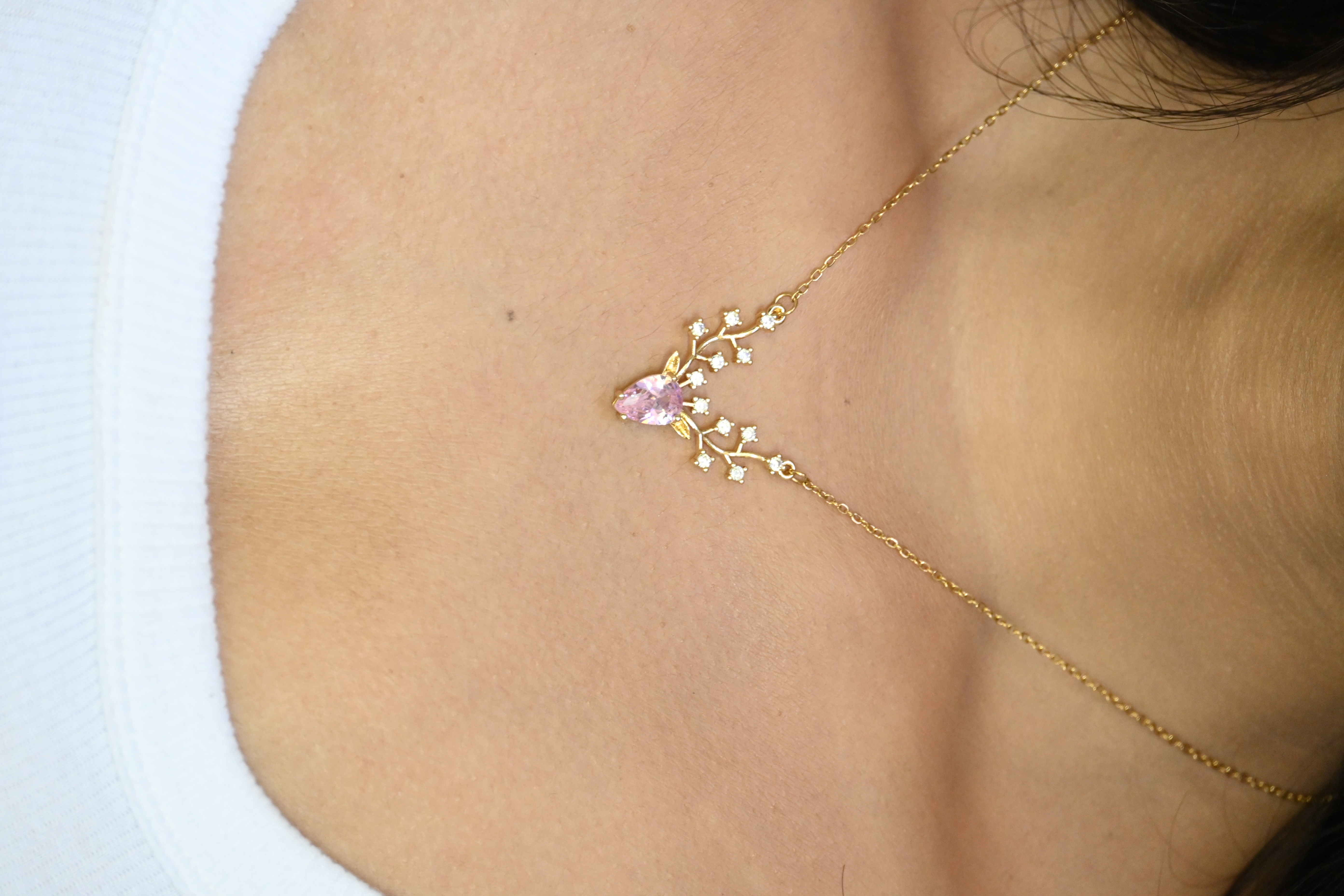 A deer-shaped necklace product shot.